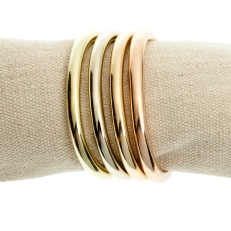 Cuffling bracelets in four gold alloys -- green, white, yellow and rose -- by contemporary jewelry designer Marla Aaron